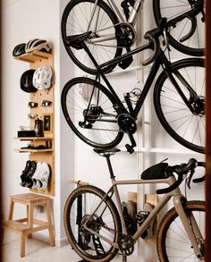 there is a bike hanging on the wall in this room with two bikes attached to it