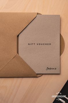 a gift voucher sitting on top of a wooden table