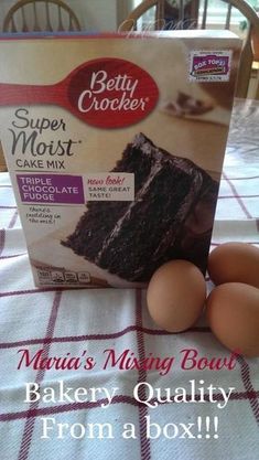 a box of cake mix sitting on top of a table next to eggs and an egg carton