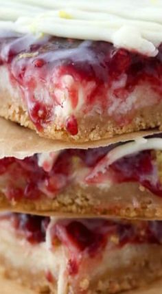 three strawberry shortbreads stacked on top of each other with icing and strawberries