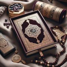 an open book surrounded by beads and other items on a table with a white cloth