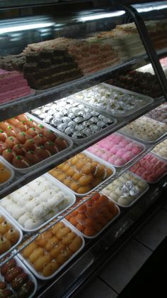 a display case filled with lots of different types of donuts and other desserts