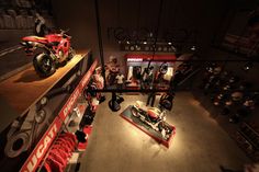 motorcycles are on display in a museum with people looking at them