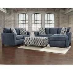 a living room with two couches and a footstool