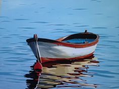 a boat floating on top of a body of water next to a red oar