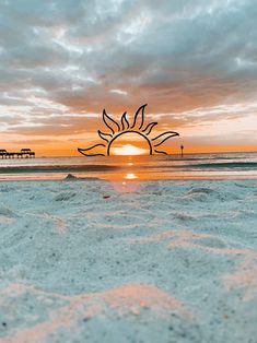 the sun is setting over the beach and water