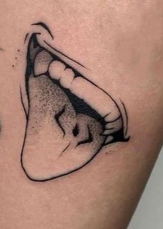 a close up of a person's stomach with an open mouth tattoo on it