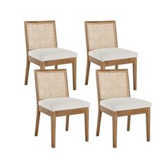 four wooden chairs with white cushions on them