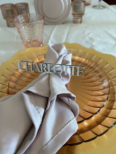 there is a place setting with napkins and glasses on the table, ready to be served