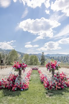 an outdoor ceremony set up with flower arrangements