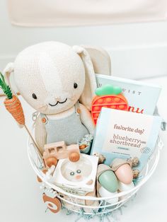 a basket filled with toys and books on top of a table