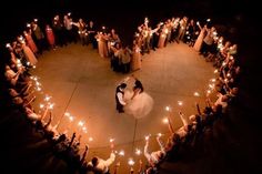 a bride and groom are surrounded by sparklers in the shape of a heart