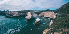 an aerial view of the ocean and cliffs