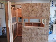 an unfinished room with wooden walls and shelves