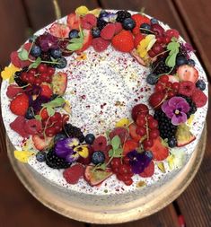 a cake with berries, raspberries and other fruits on it