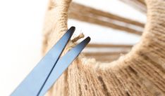 a pair of blue handled scissors stuck in the side of a sweater