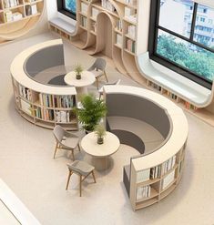 an aerial view of a library with tables, chairs and bookshelves in it