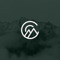 the mountain logo is shown in white on a dark green background with clouds and mountains behind it