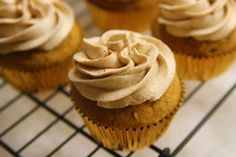 cupcakes with frosting sitting on a cooling rack