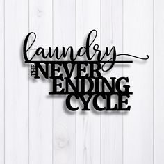 a metal sign that says laundry never ending cycle on a white wooden background with black lettering