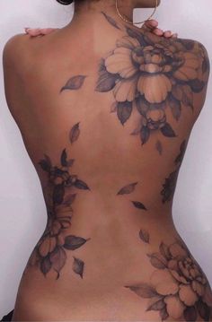 the back of a woman's body with flowers on it