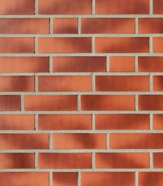 a red brick wall is shown in close up