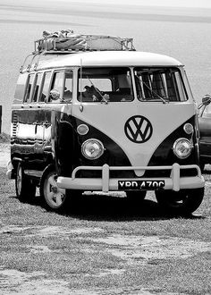 an old vw bus is parked on the beach