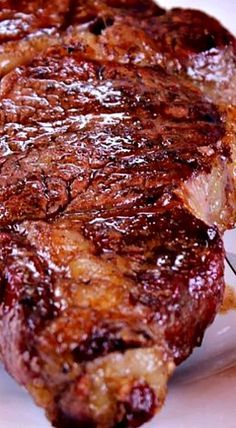 a piece of steak on a white plate