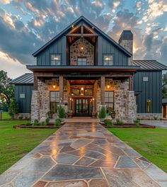 a large house that is in the middle of a grassy area with a stone walkway leading to it