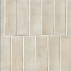 a white tiled wall with vertical lines on it