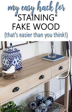 a wooden table with blue and white vases on it, next to a mirror that says my easy hack for staining fake wood that's easier than you think