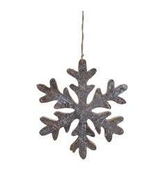 a metal snowflake ornament hanging from a string on a white background