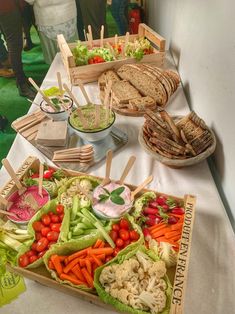 a table topped with lots of different types of food on top of a white table cloth