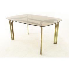 a glass table with metal legs on a white background