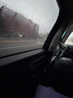 the inside of a car with rain on the windshield