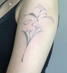 a woman's arm with a flower tattoo on the left side of her body