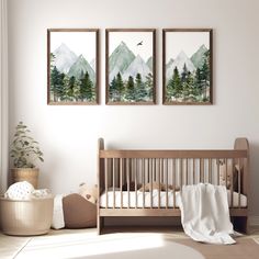 a baby's room with two paintings on the wall and a crib next to it