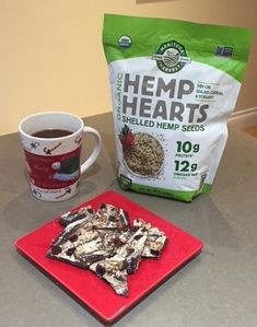 a bag of hemp hearts next to a cup of coffee on a red plate