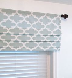 a blue and white roman blind in a room