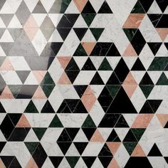 an artistic tiled wall with black and white triangles