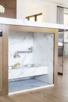 a bathroom with marble walls and wooden floors