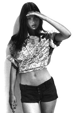 black and white photograph of a woman in short shorts with her hand on her head