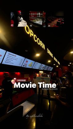 the movie time sign is lit up in the dark room with people sitting at tables