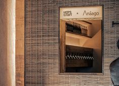 a bathroom with a sink and mirror next to a wooden shelf filled with wine bottles