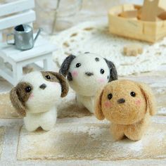 three small stuffed dogs sitting next to each other