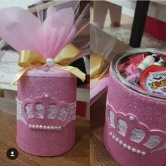 two pink tins with princess crowns on them sitting on a table next to each other