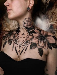 a woman with tattoos on her neck and chest