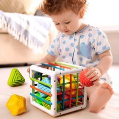 a toddler playing with a toy basket on the floor