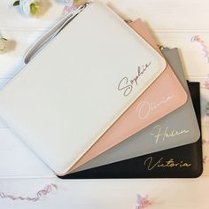 three personalized notebooks sitting on top of each other