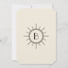 a white card with the letter b on it and sunbursts around it